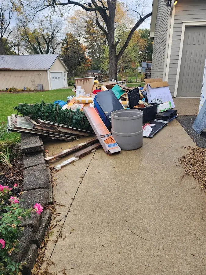 Dumpster being loaded with debris for 12 Yard Dumpster Rental in Sheboygan